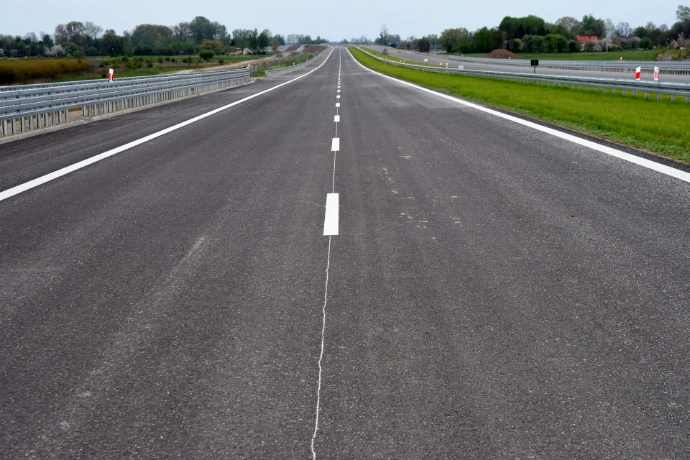 Empty highway stretching into the distance under a clear sky